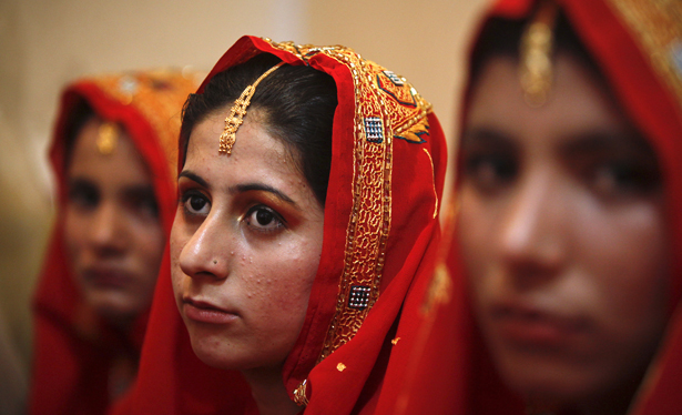 Brides-to-be wait during a mass wedding ceremony in Karachi